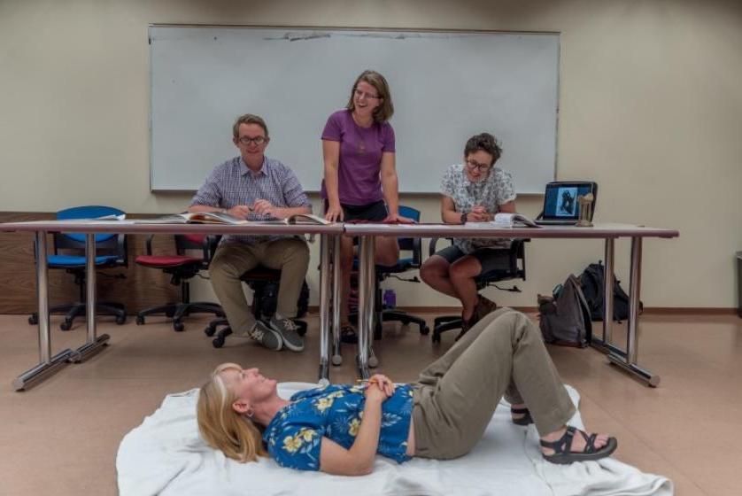 Professor Bonnie Clark tries out a replica of a Somali headrest